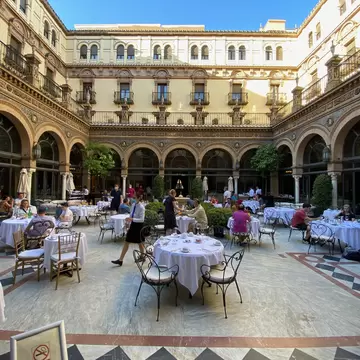 Seville, Spain - April 20 2018: Breakfast tables in the interior courtyard of the historical Hotel Alfonso XIII, a Luxury Collection Hote