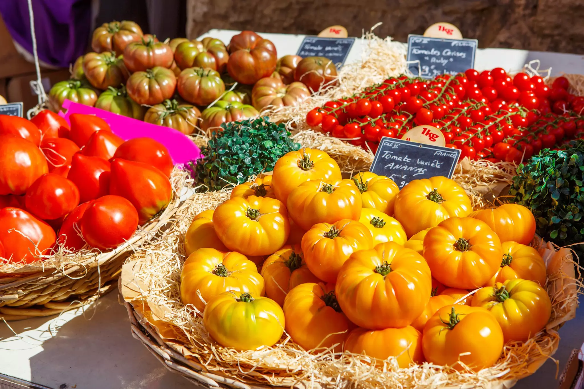 Fresh coloured different tomatoes in a local food market