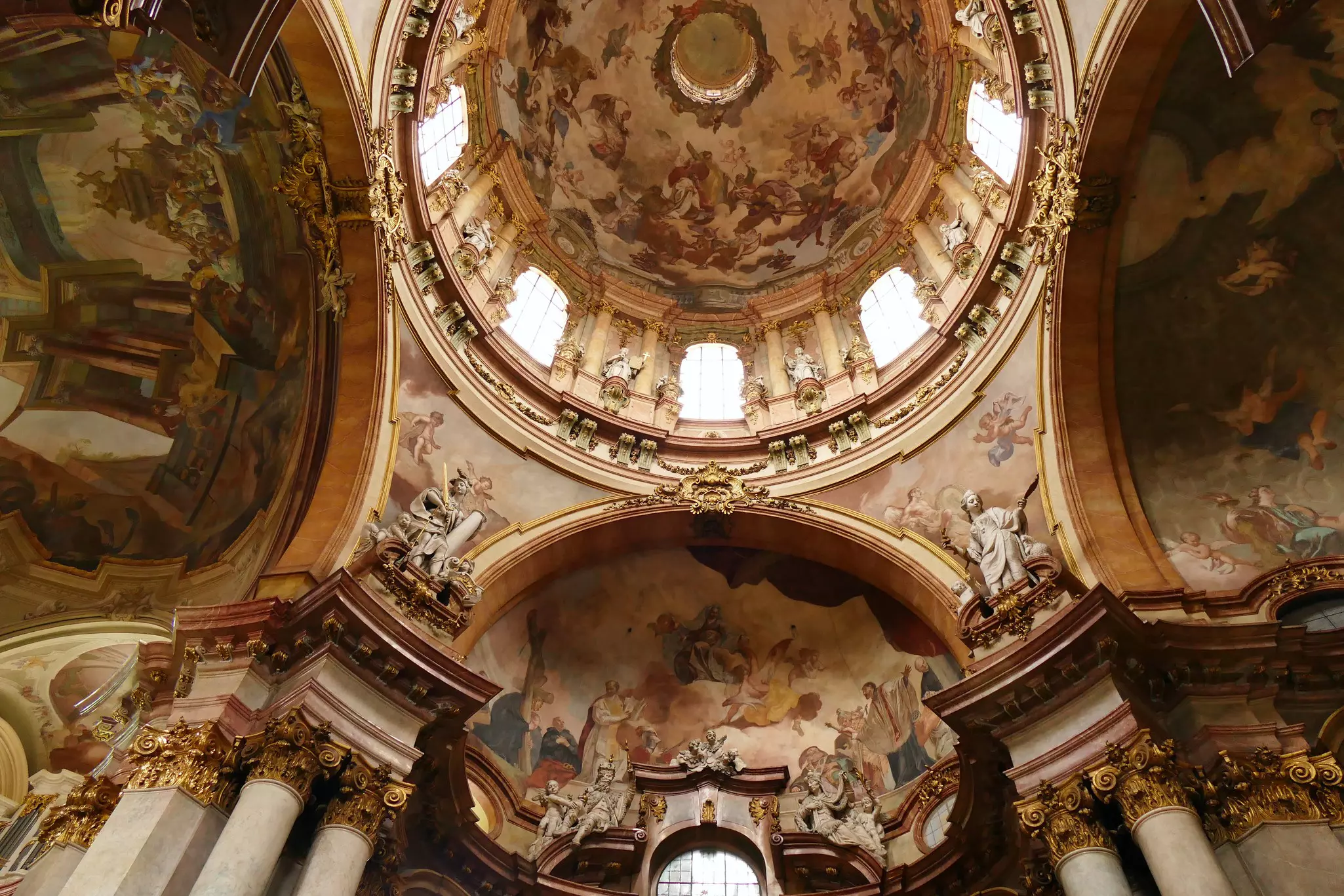 Details inside the decorative dome of St Nicholas Church with light coming in through the windows