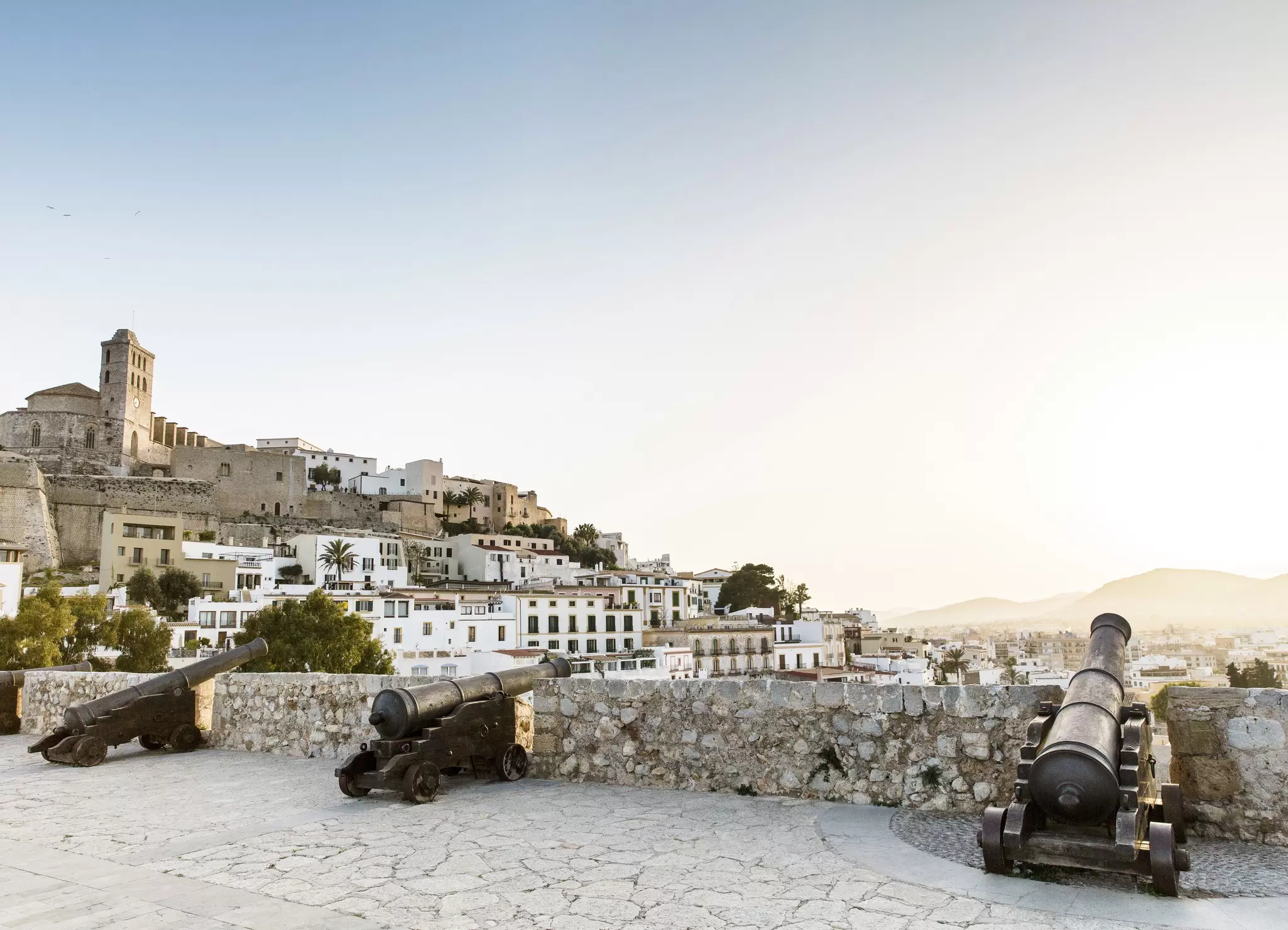 Cannons look out of fortified walls near an ancient hilltop church in Dalt Villa, Ibiza. 