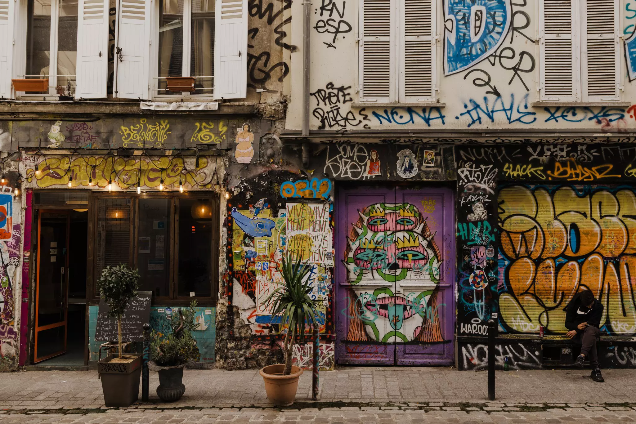 Street art on Rue Denoyez, Paris, France.