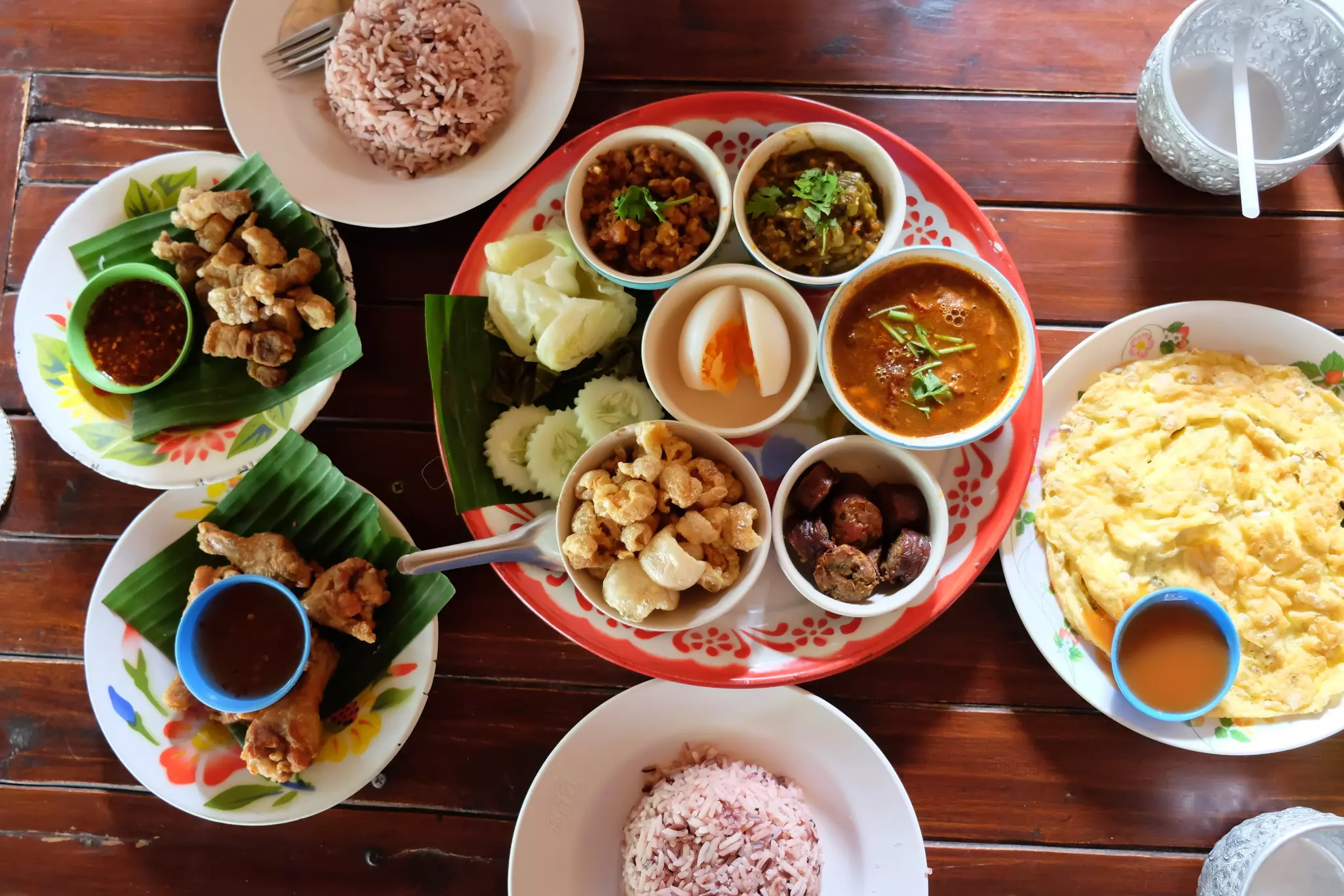 An assortment of plated Chiang Mai cuisine on a wooden table