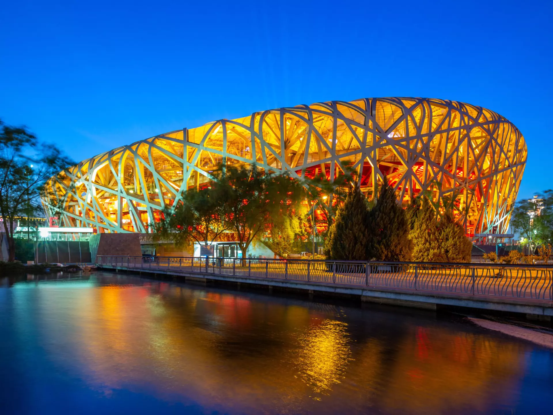 May 6, 2019: Exterior of Beijing National Stadium (also known as the Bird's Nest) lit up at night.
1153365475
Bird's Nest, Asia, China, Famous Place, Asian, Stadium, Travel Destinations, Horizontal, Tourist, Light - Natural Phenomenon, Photography, Night, International, Neon Lighting, World, Summer, Beijing, Park, Sport, Built Structure, Outdoors, Building, Water, Dusk, Capital Cities, The Olympic Games, Scene, Light, National, Cityscape, Architecture, Bridge - Built Structure, Modern, Lighting Equipment, Travel, Twilight, Bird, Tour, Landscape, Beauty, Famous, Tourism, Bridge, Sunset, City, View, Attraction, Animal Nest, Olympic, China - East Asia, Pond, Architectural Dome, Chinese, Reflection, Game