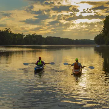 Couple kayaking in the James River at sunset in Richmond, Virginia