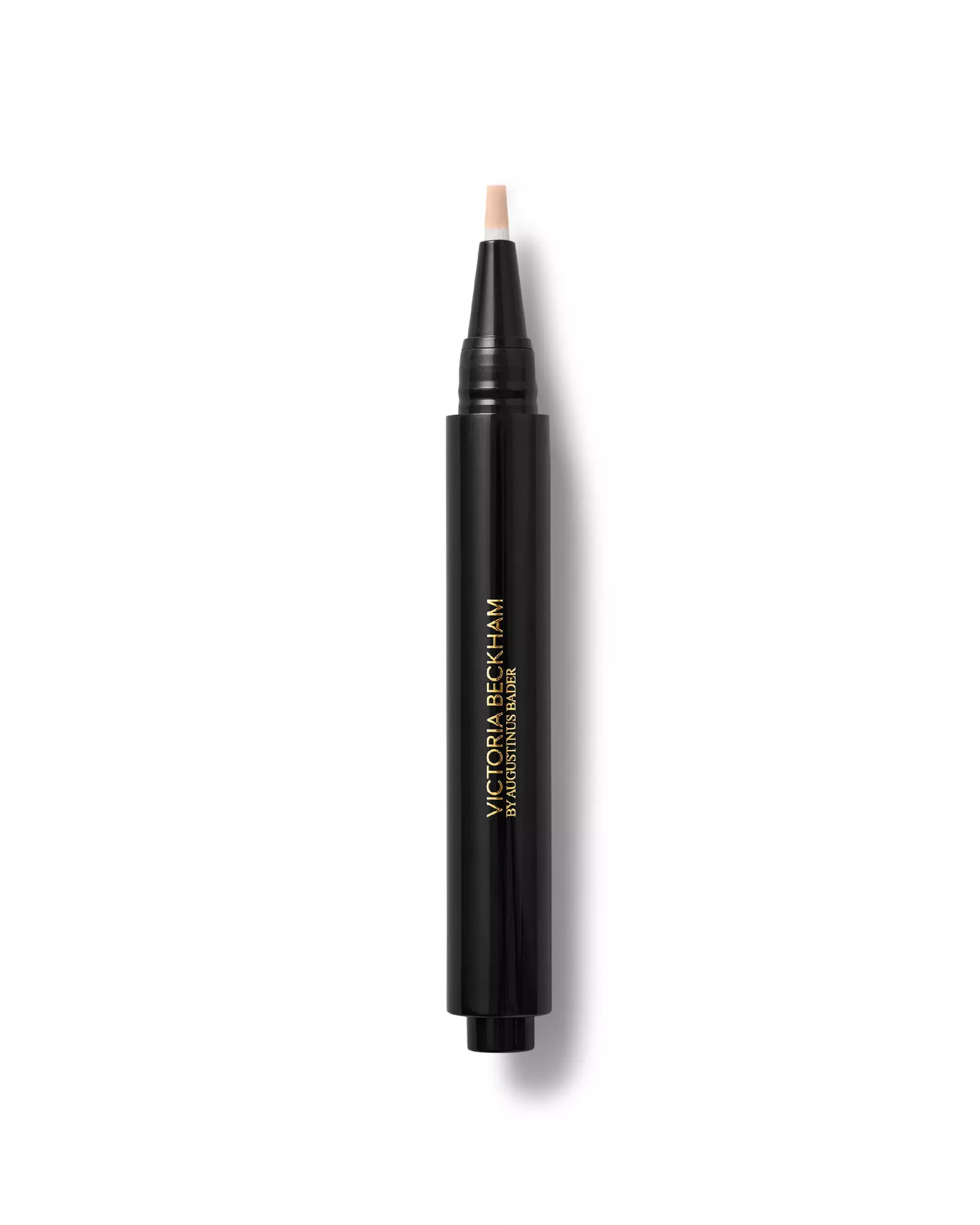 A black concealer pen is presented on a white background, there's a small bit of concealer oozing from the tip of the pen.