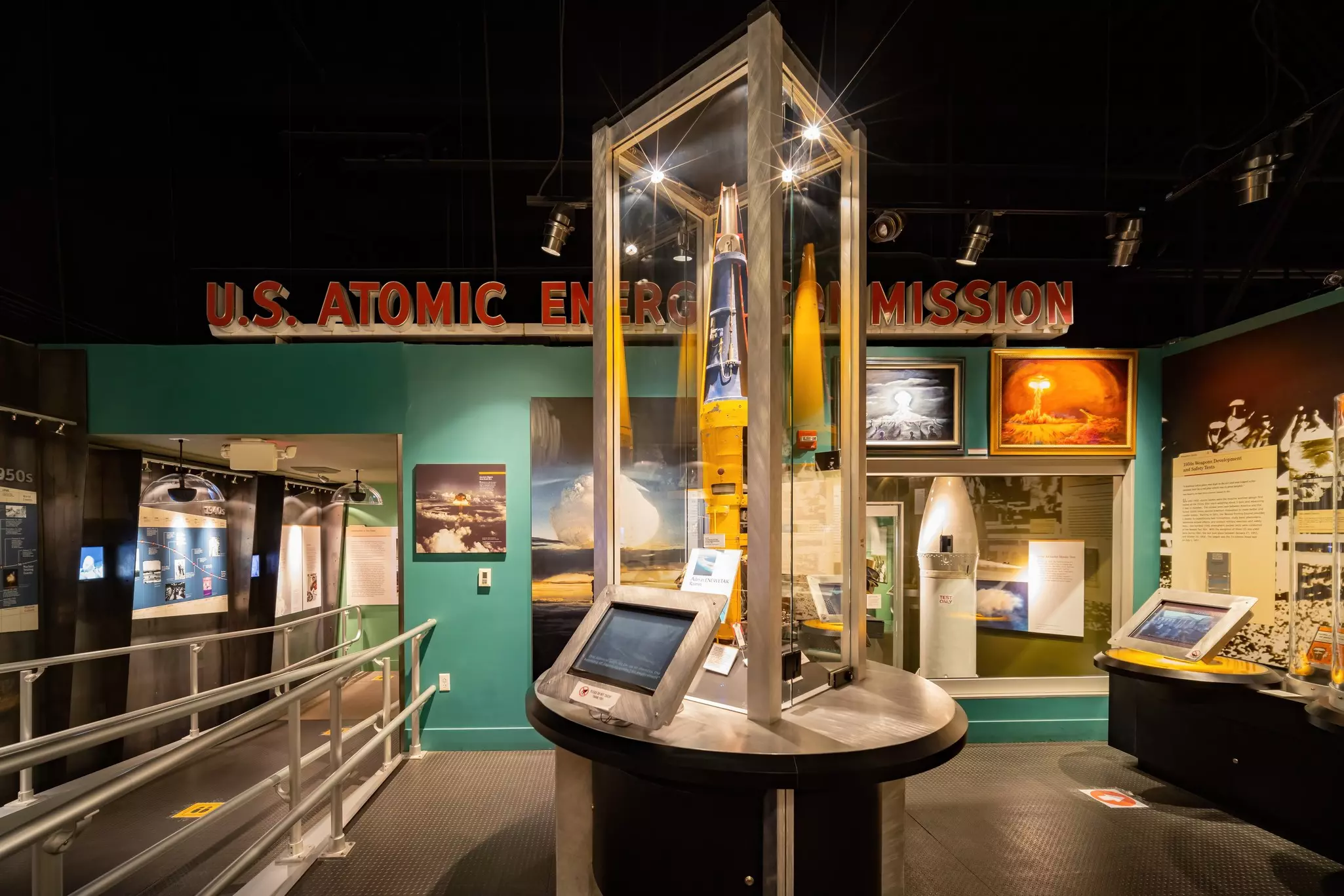 A museum display showing a rocket-like item in a glass case