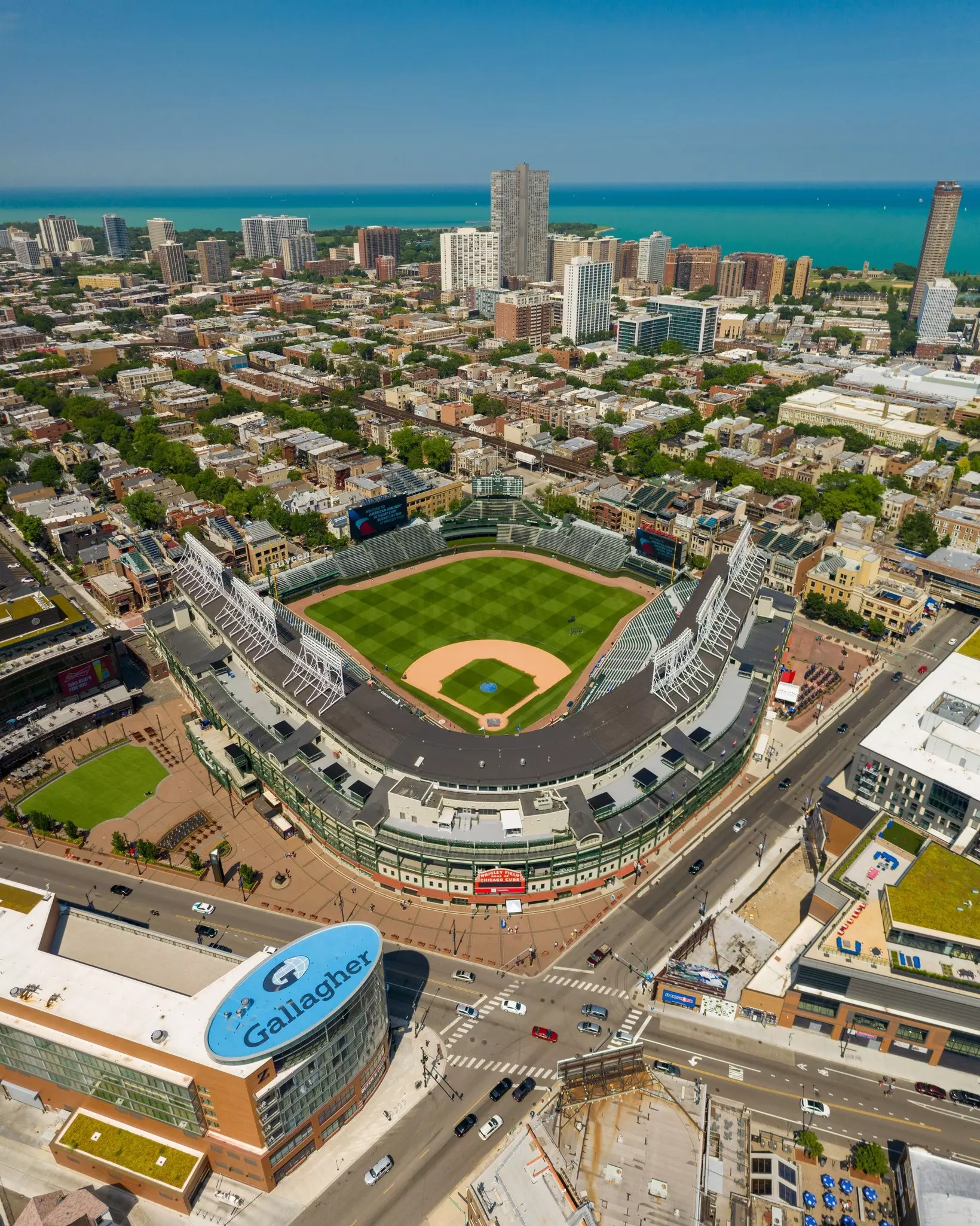 An aerial view of the baseball stadium Wrigley Field, with Lake Michigan in the background