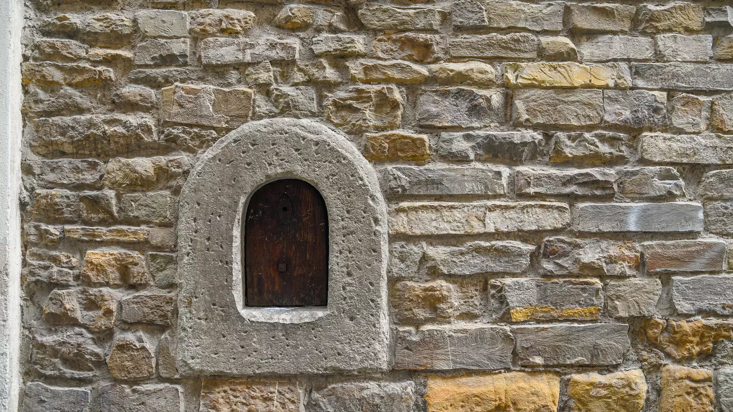Detail of an old stone wall with a wine window in Florence ©Simona Sirio/Getty Images/iStockphoto