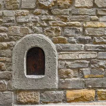 Detail of an old stone wall with a wine window in Florence ©Simona Sirio/Getty Images/iStockphoto