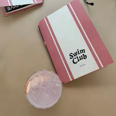 A cocktail and menu at Swim Club