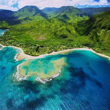 An aerial photo of Tunnels beach. Tunnels is located on Kauai's North Shore and is named after the tunnels that snorkelers and divers can observe when navigating the reef.
181172047
Aerial View; Beach; Kauai; Outdoors; Snorkeling; Horizontal; No People; Tunnels Beach; Pacific Islands; Photography; Hanalei Bay; Hawaii Islands; Reef;