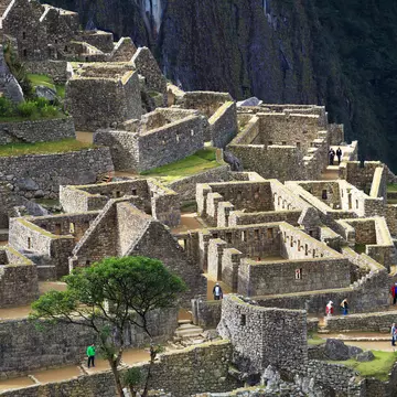 Visitors explore the ruins of Machu Picchu.
228805123
archaeological, peru, destination, america, historical, stone, latin, natural, mystery, cloud, travel, wonder, rock, lost, culture, landmark, civilization, history, old, tour, tourist, world, unesco, famous, heritage, city, ruin, mist, mountain, inca, terrace, andes, tourism, peruvian, ancient, background, nature, construction, road, landscape, cusco, machu, picchu, urubamba, incan