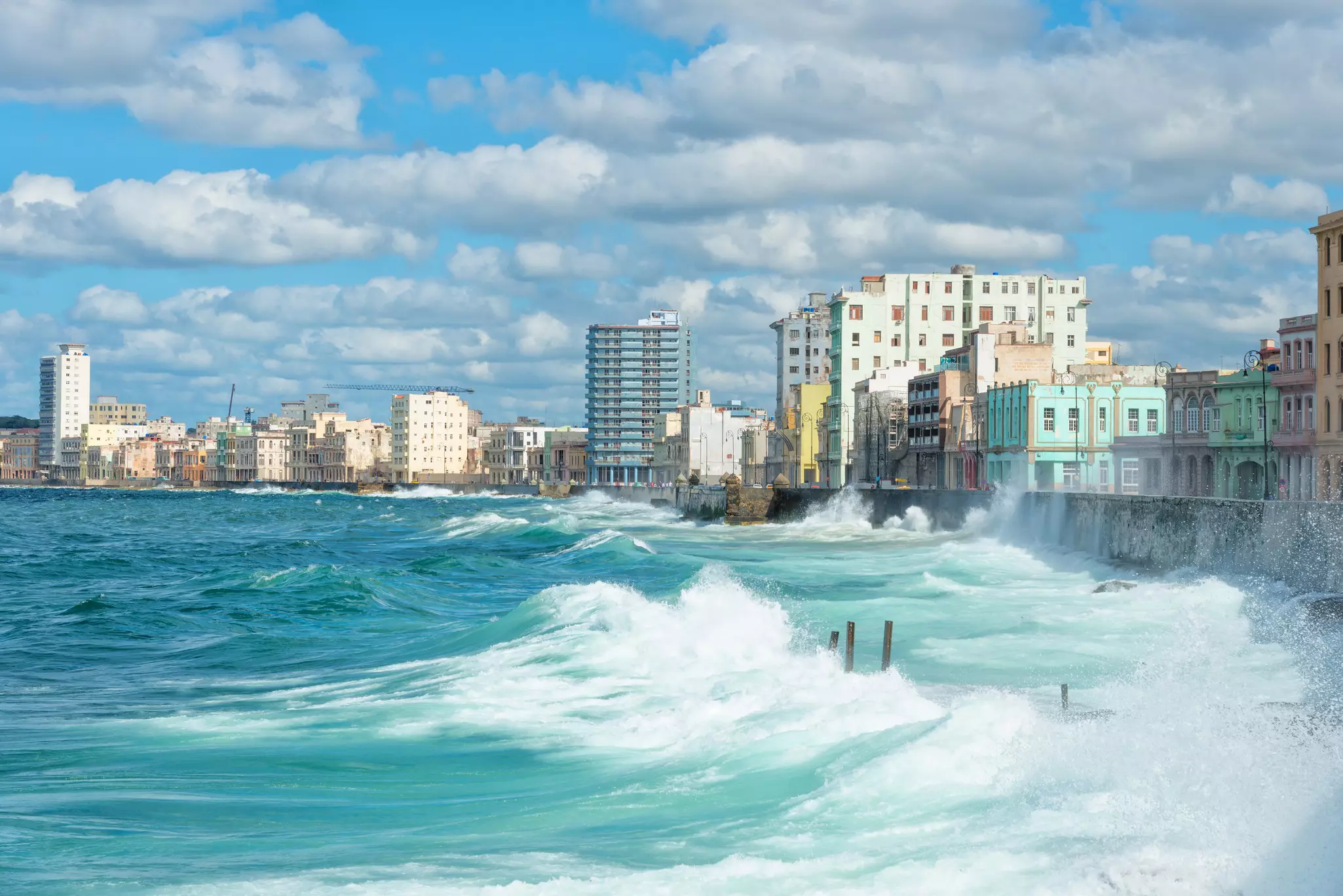 Large waves hitting a city's sea wall.
