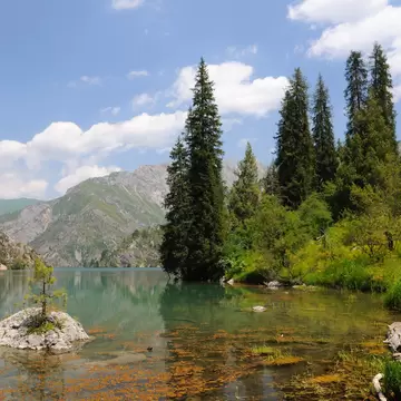 Colorful and amazing Sary-Chelek Lake with lakeside, mountains, fur-trees, sky and clouds; Shutterstock ID 61984723;