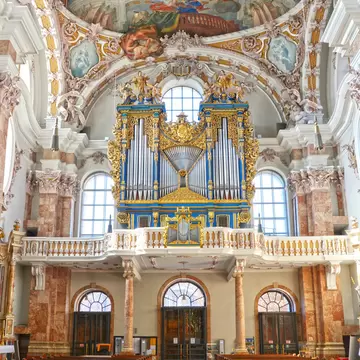 Blue and gold baroque organ beneath painted ceiling frescoes inside Dom St Jakob cathedral, Innsbruck