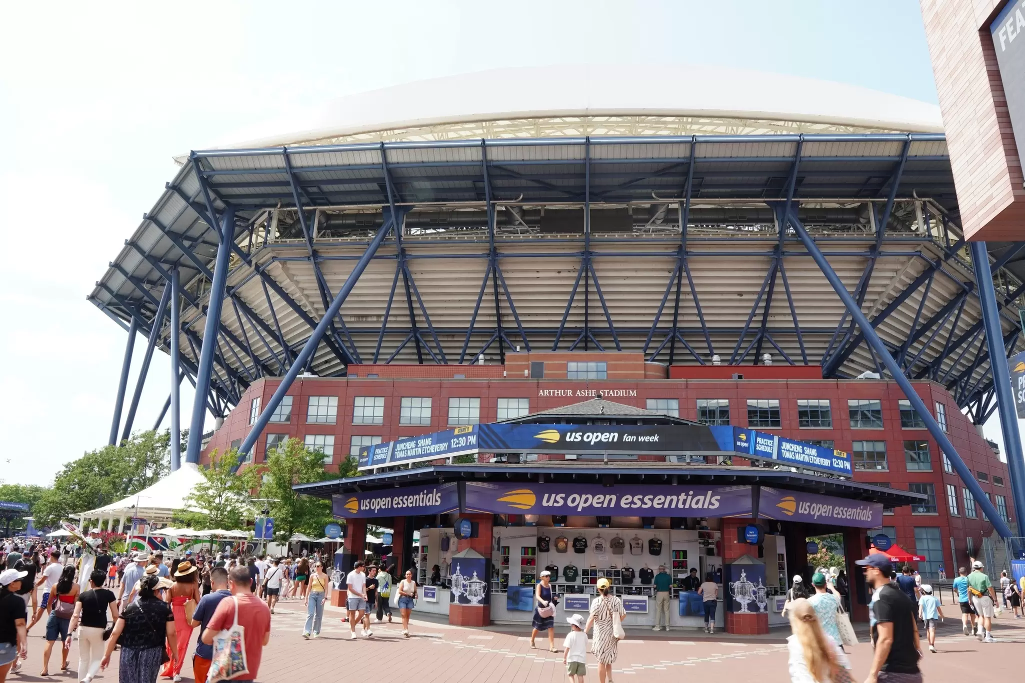 Spectators mill around the outside of Arthur Ashe Stadium at Billy Jean King Tennis Center in Queens, NY.