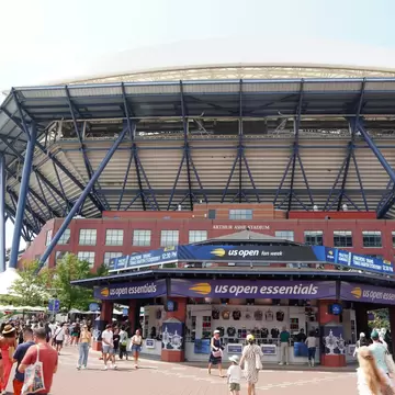 Spectators mill around the outside of Arthur Ashe Stadium at Billy Jean King Tennis Center in Queens, NY.
