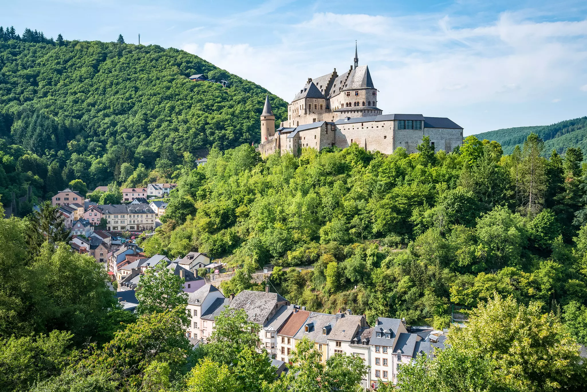The medieval castle rises above the town streets in Vianden, Luxembourg.