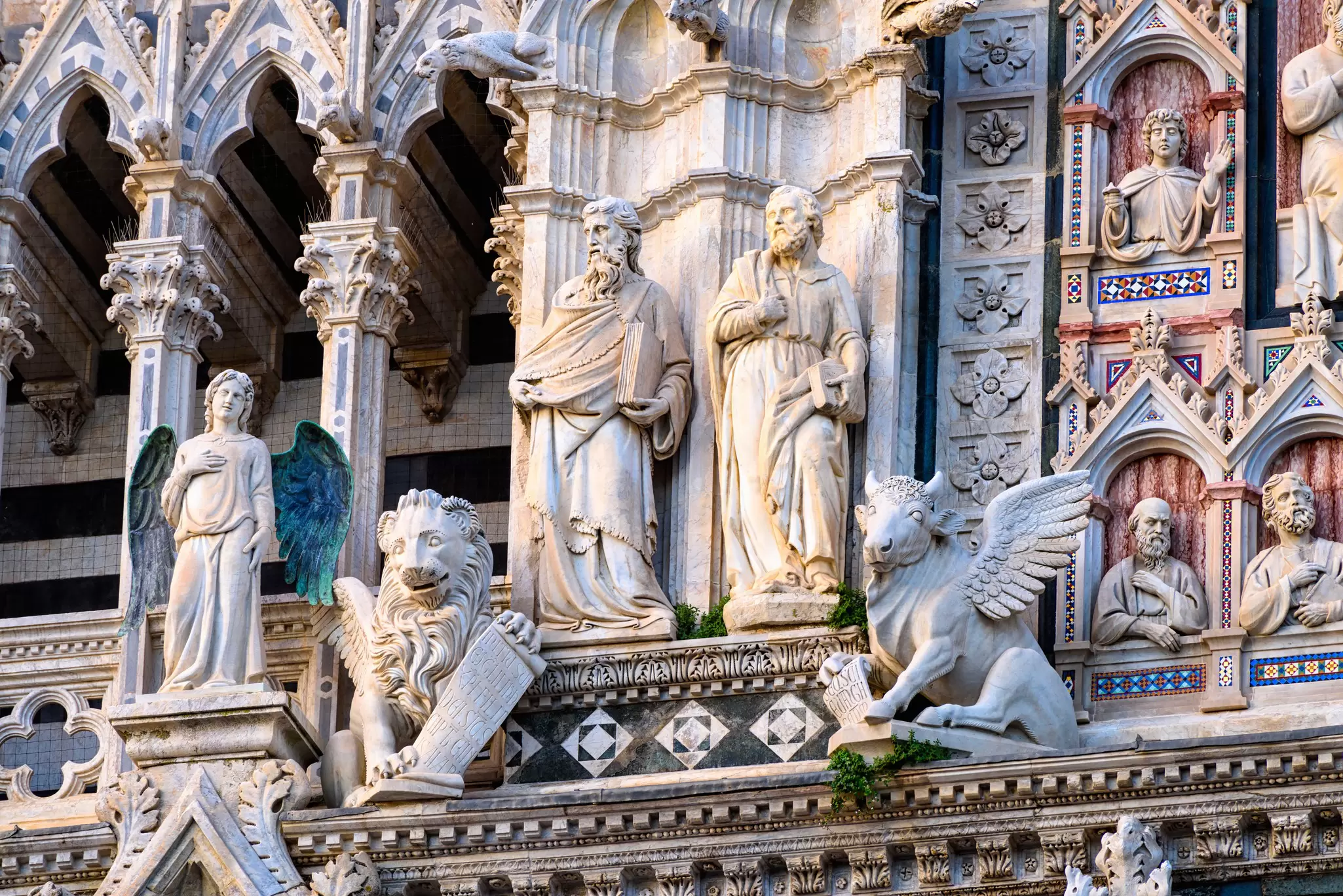 Sculptures on the facade of Siena Cathedral, Santa Maria Assunta (Duomo di Siena) in Siena, Tuscany.
