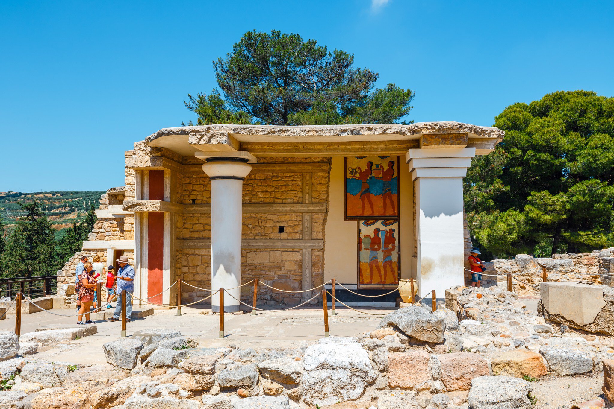 Visitors exploring the ancient Minoan Palace of Knossos near Heraklion, Crete, Greece