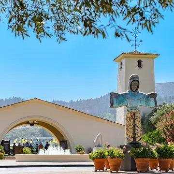 NAPA VALLEY, CALIFORNIA - AUGUST 17, 2019: Robert Mondavi Winery, Kalon Vineyard entrance, with statue of St. Francis of Assisi by sculptor Beniamino Bufano in the foreground.  License Type: media  Download Time: 2021-01-27T13:39:52.000Z  User:   Is Editorial: Yes  purchase_order:   