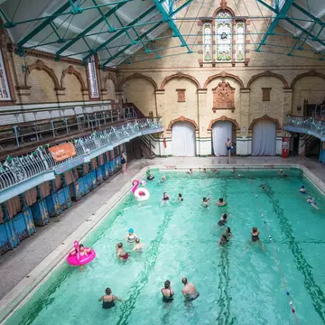 People Swimming in the Men's First Class Pool at Victoria Baths in Manchester, which is having an open swim day to raise funds for restoration work. - Image ID: J4XR5T,
