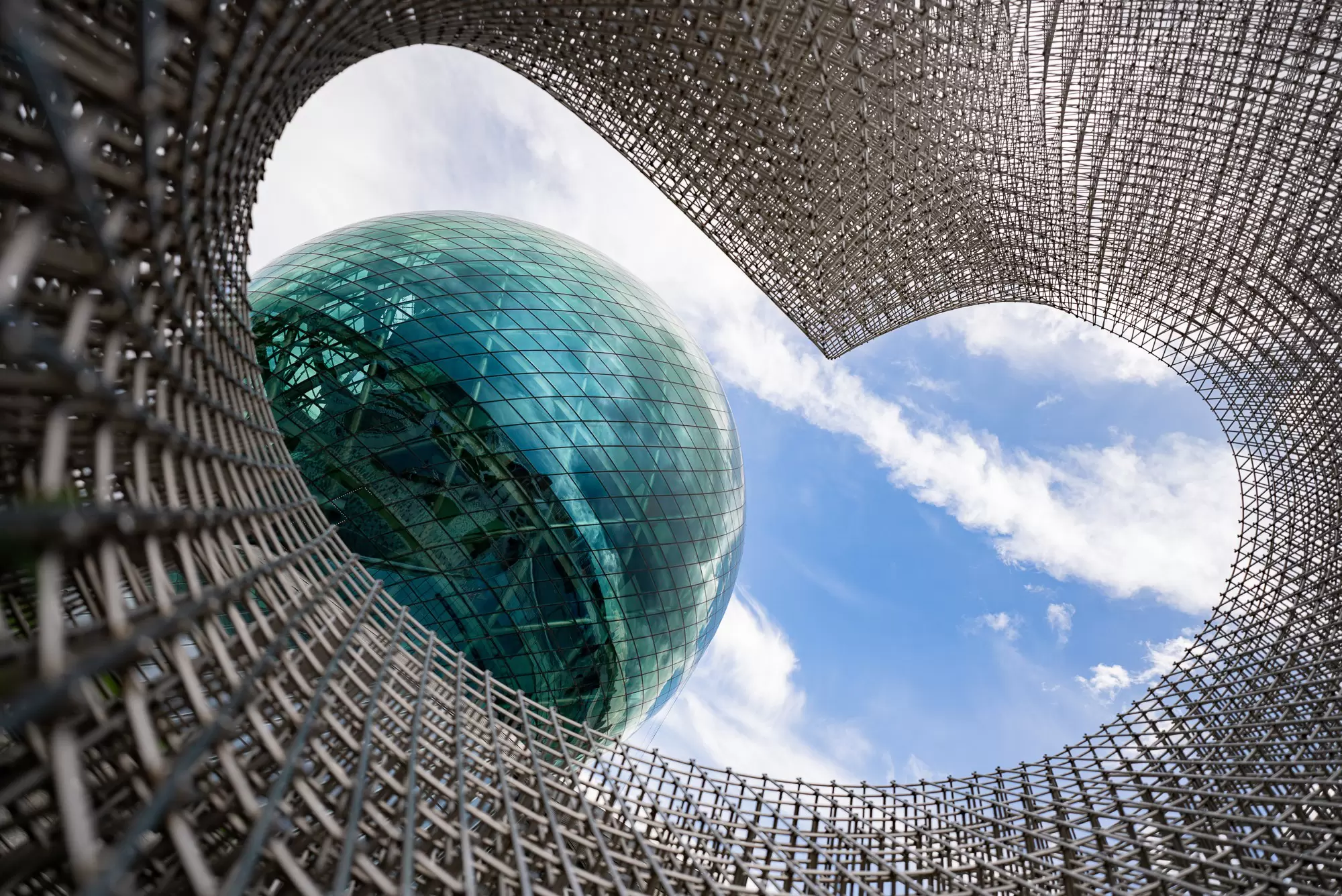 Looking up at the rounded glass dome of the Nur Alem museum in Astana, Kazakhstan.