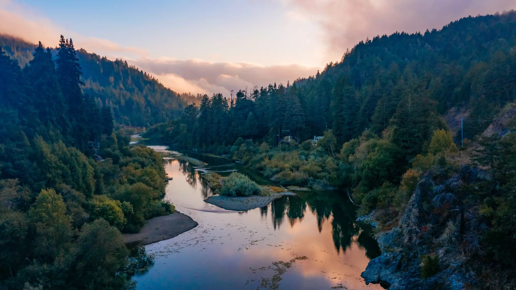A view of the Russian River and surrounding trees and buildings