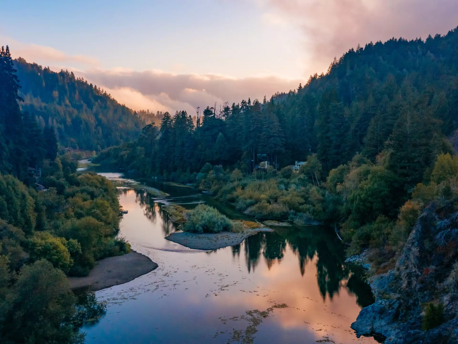A view of the Russian River and surrounding trees and buildings