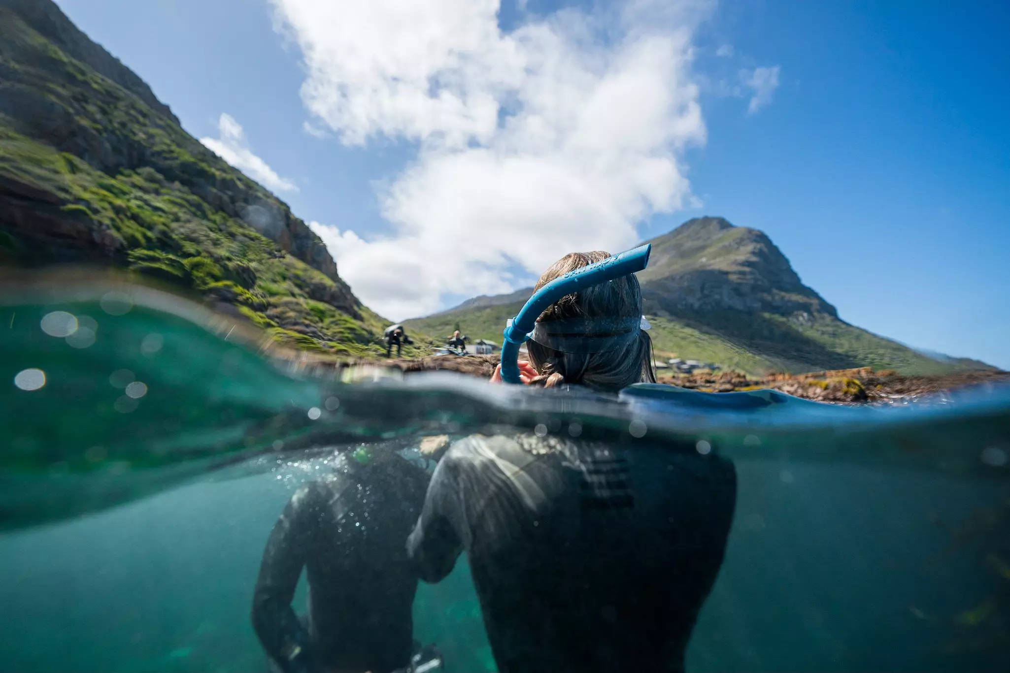 Looking into the water as people scuba dive.