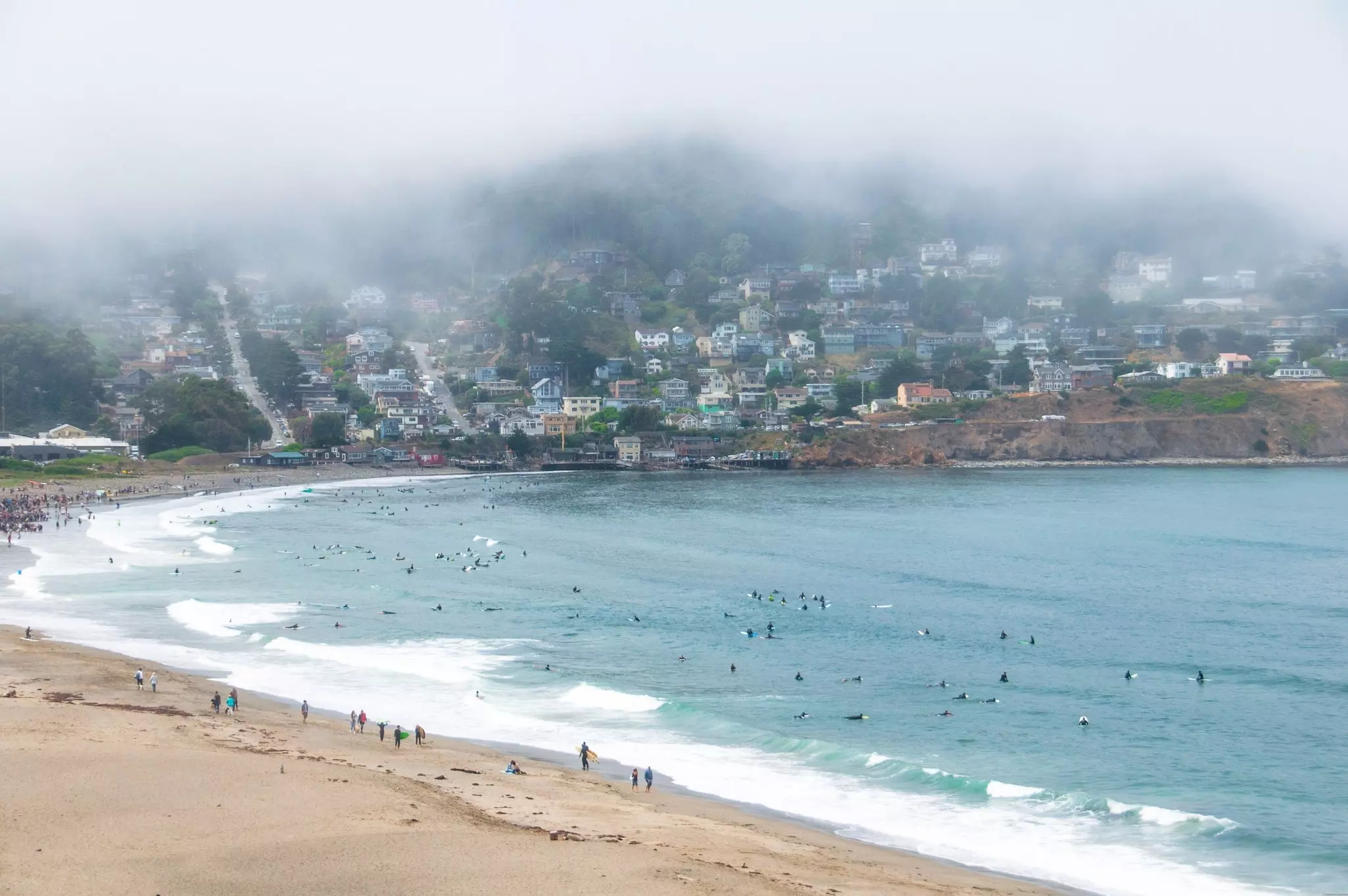 A sandy beach on a foggy morning.