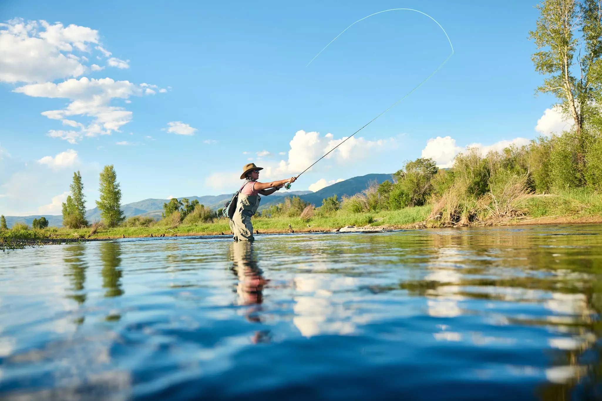 A man fly fishing on the Yampa River in Steamboat Springs, Colorado, USA.