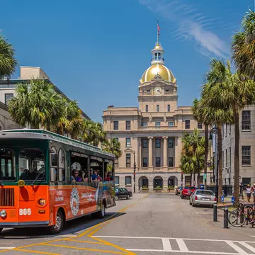 A trolley tour bus rolls through downtown Savannah, Georgia. Darryl Brooks/Shutterstock