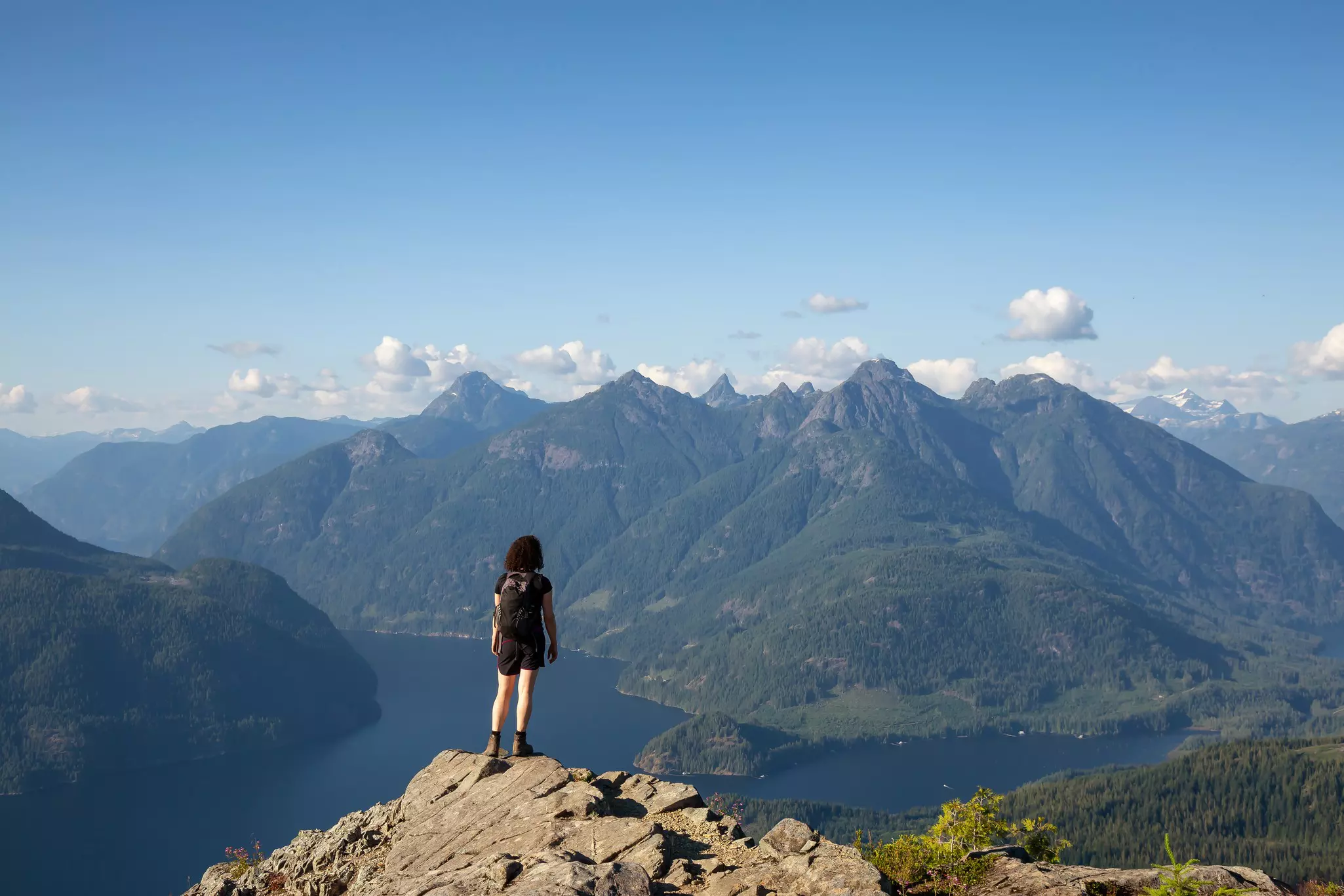 Girl on top of Tin Hat mountain, part of the Sunshine Coast trail in Powell River, British Columbia, Canada