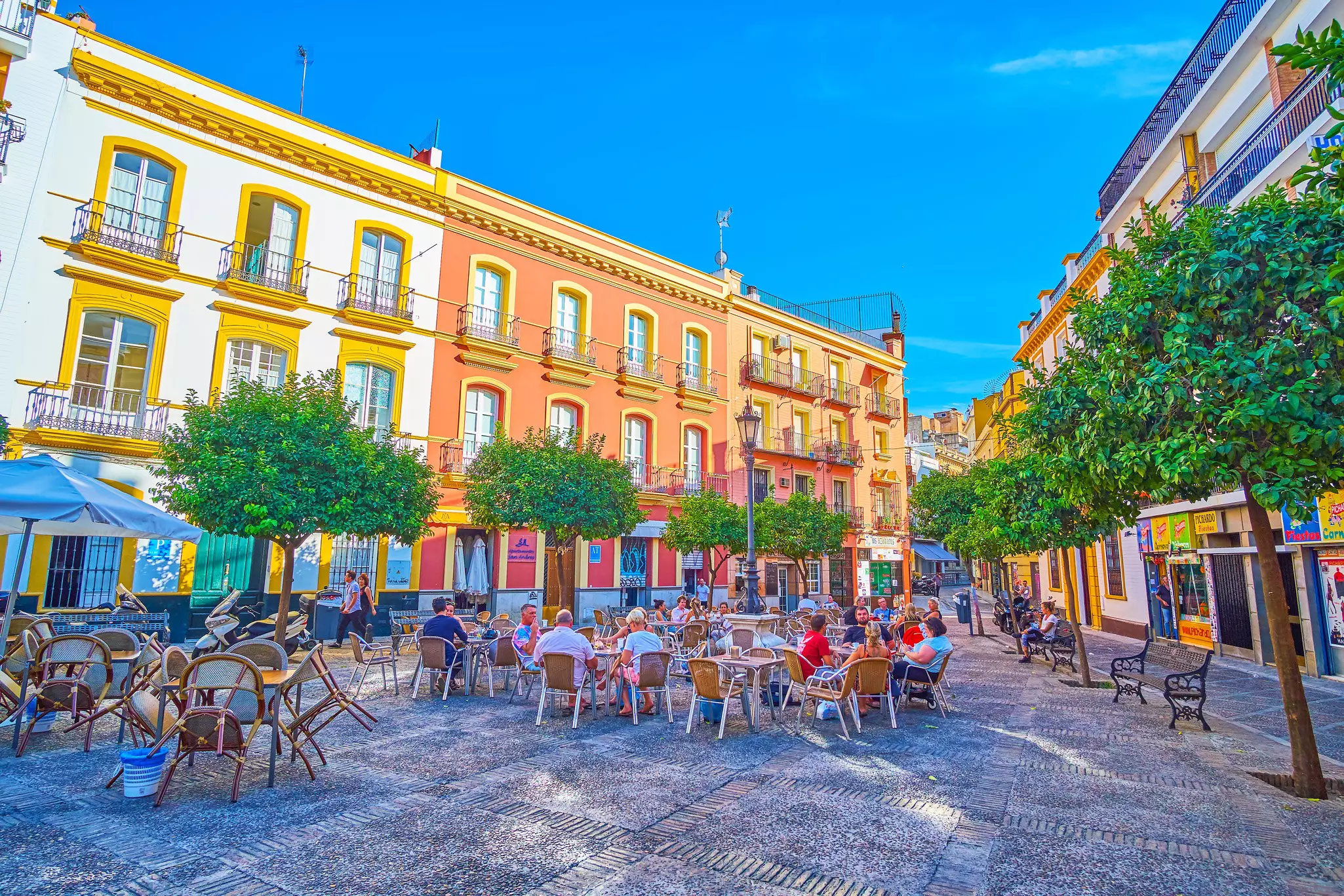 The small triangle Plaza de San Andres with outdoor cafe tables in Seville