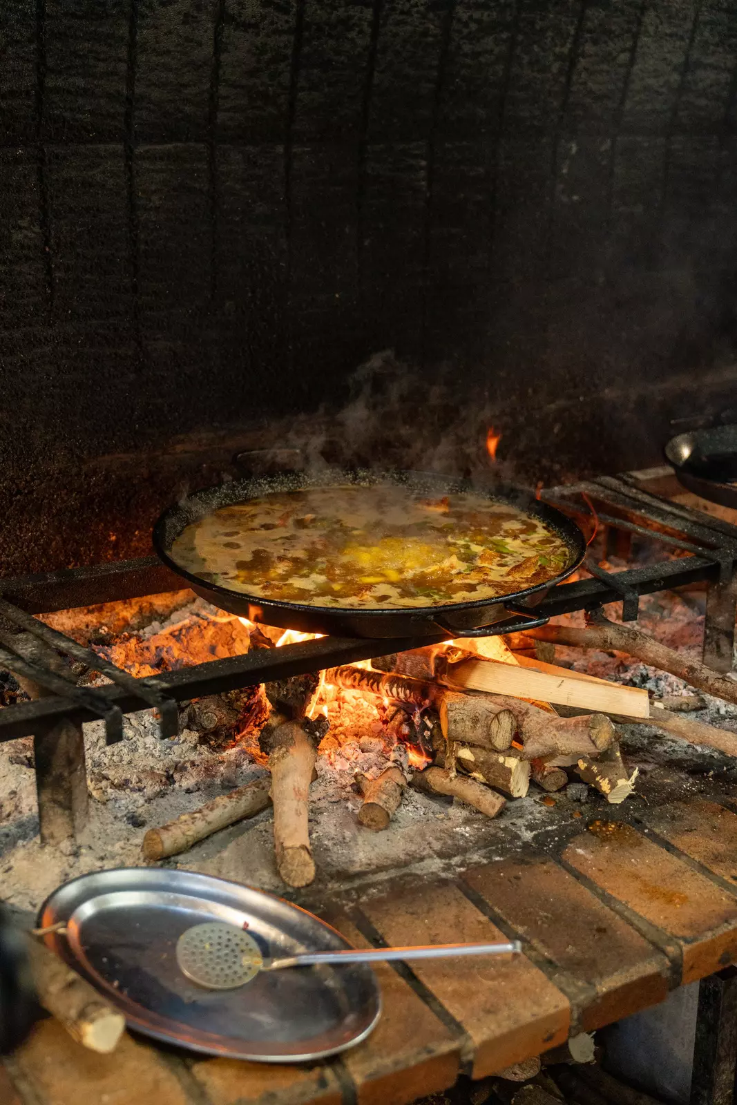 Paella is traditionally cooked over an open flame.