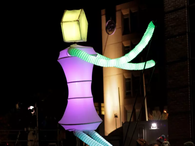 An illuminated figure at a parade.