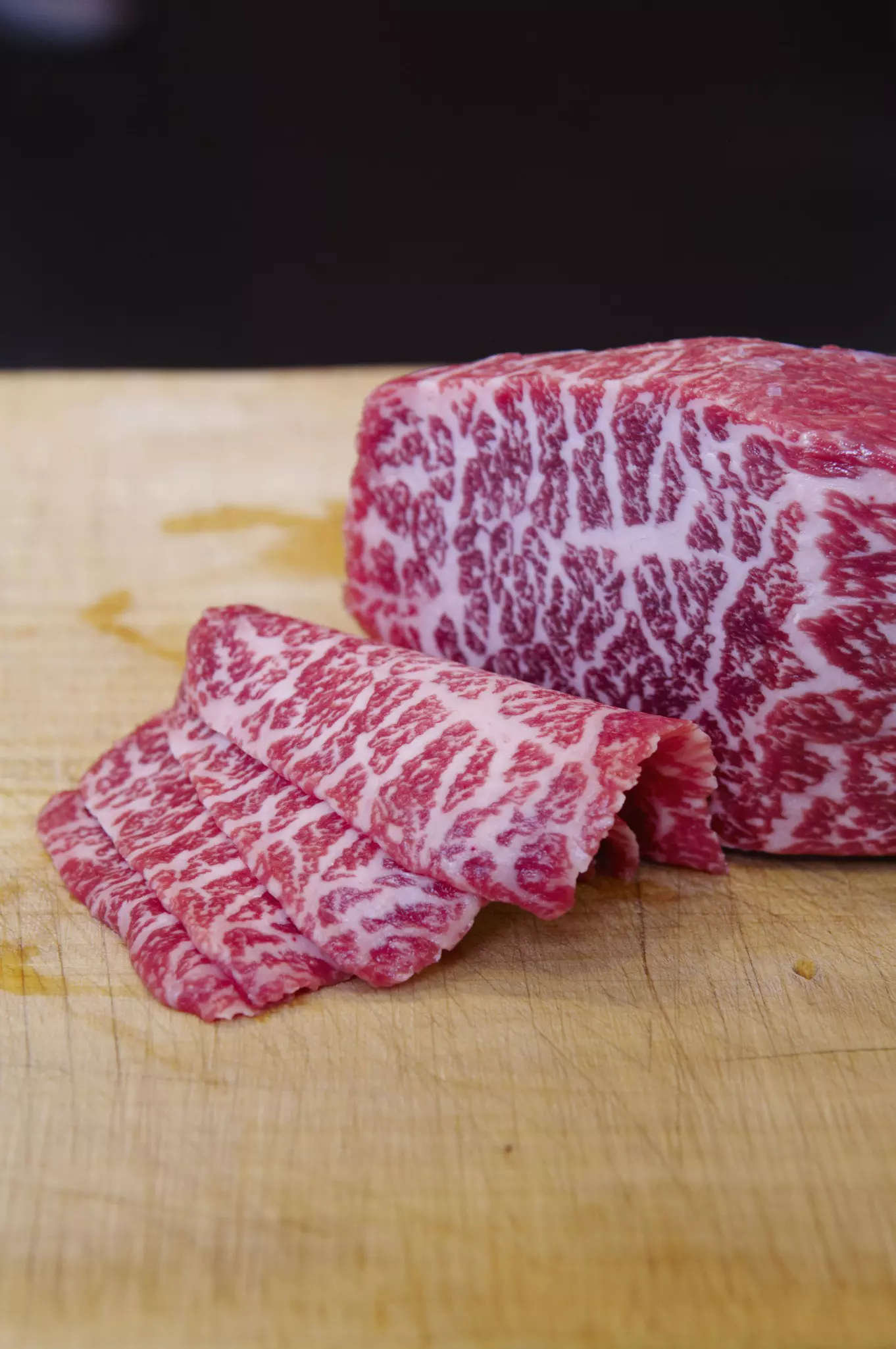 Thinly sliced uncooked Kobe beef with red and white flesh