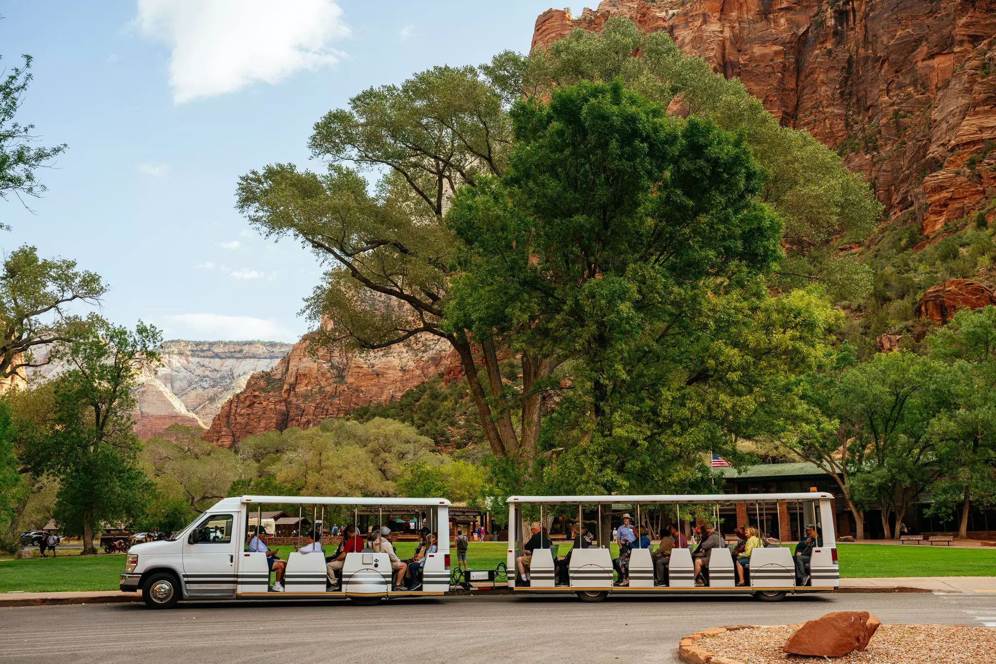 Transport for visitors to Zion National Park in Utah, USA, with rocky landscapes behind.