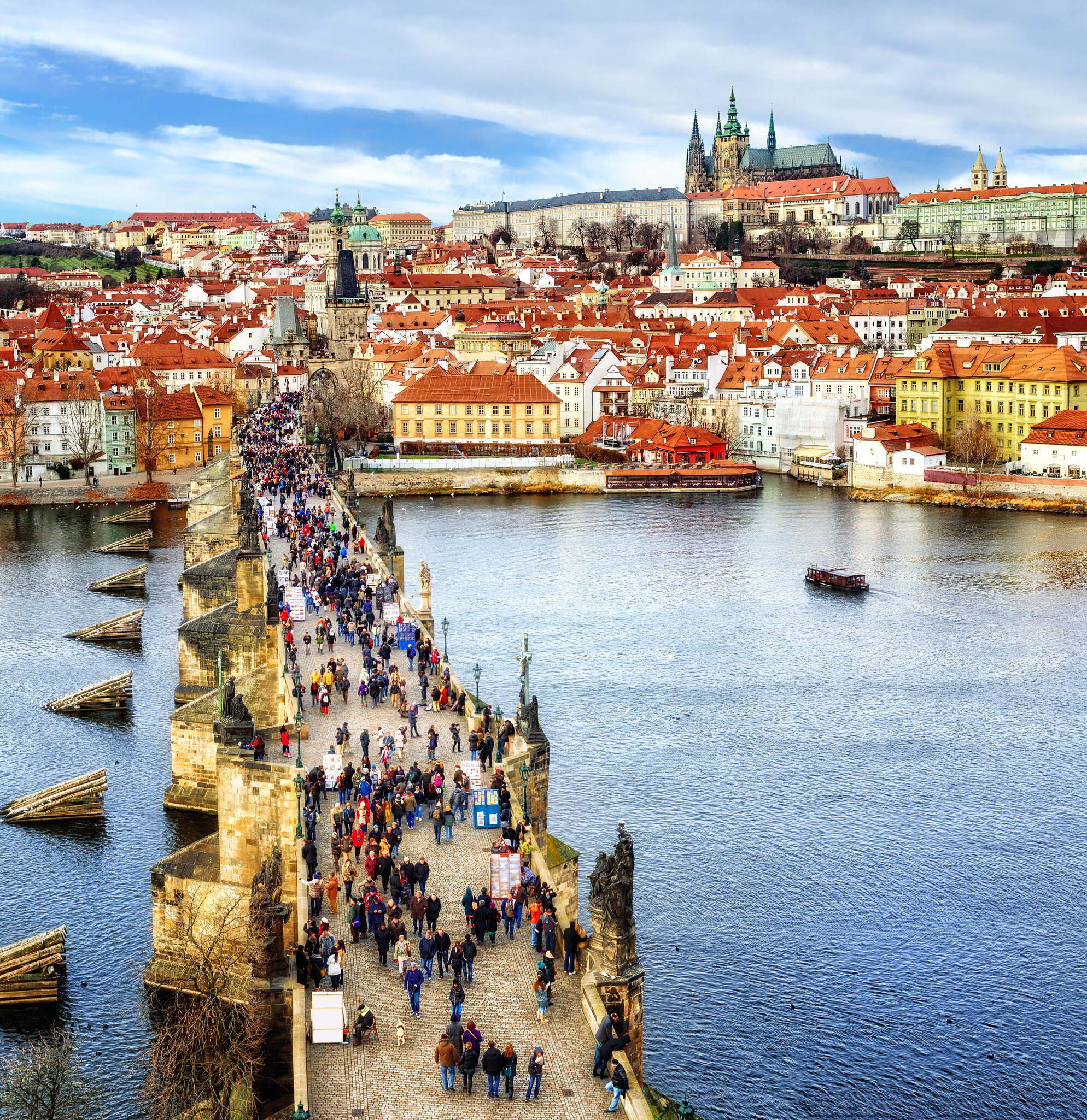 Panorama of Prague with the Castle, Charles Bridge, Vltava river and red roofs of the old town, Czech Republic.