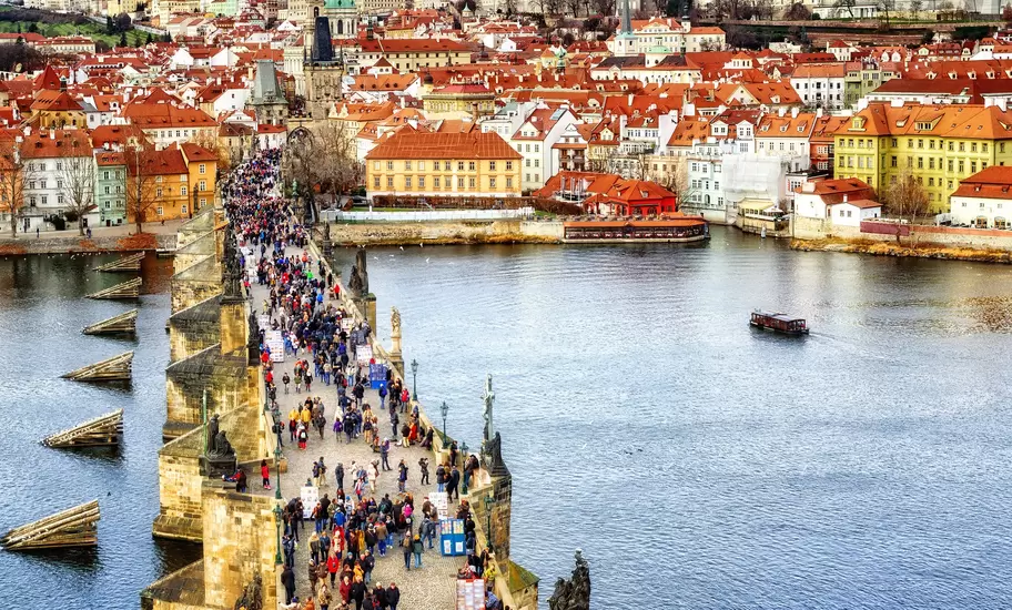 Panorama of Prague with the Castle, Charles Bridge, Vltava river and red roofs of the old town, Czech Republic.