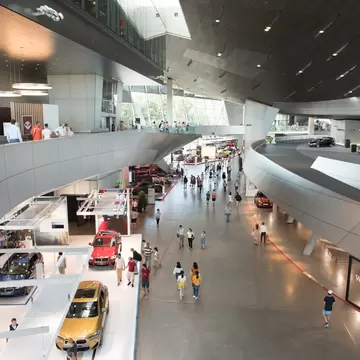 Visitors admire cars in the huge, ultra-modern galleries of BMW Welt, Munich