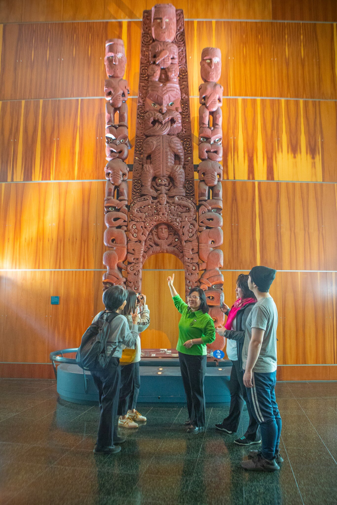 A tour guide showcases an exhibition to visitors at the Museum of New Zealand Te Papa Tongarewa.