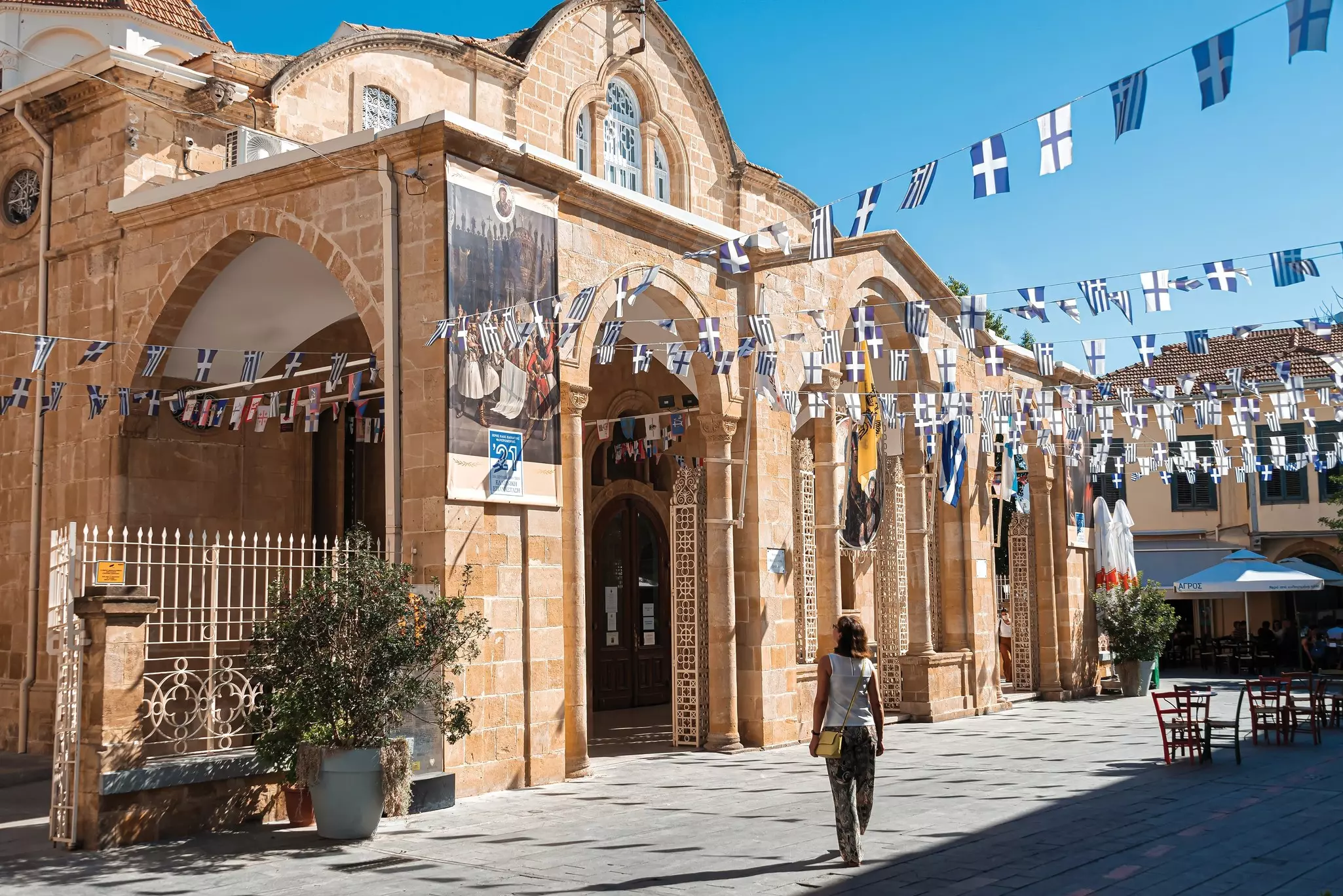 The arches of a historic church and fluttering flags in the Old City of Nicosia (Lefkosia), Cyprus.