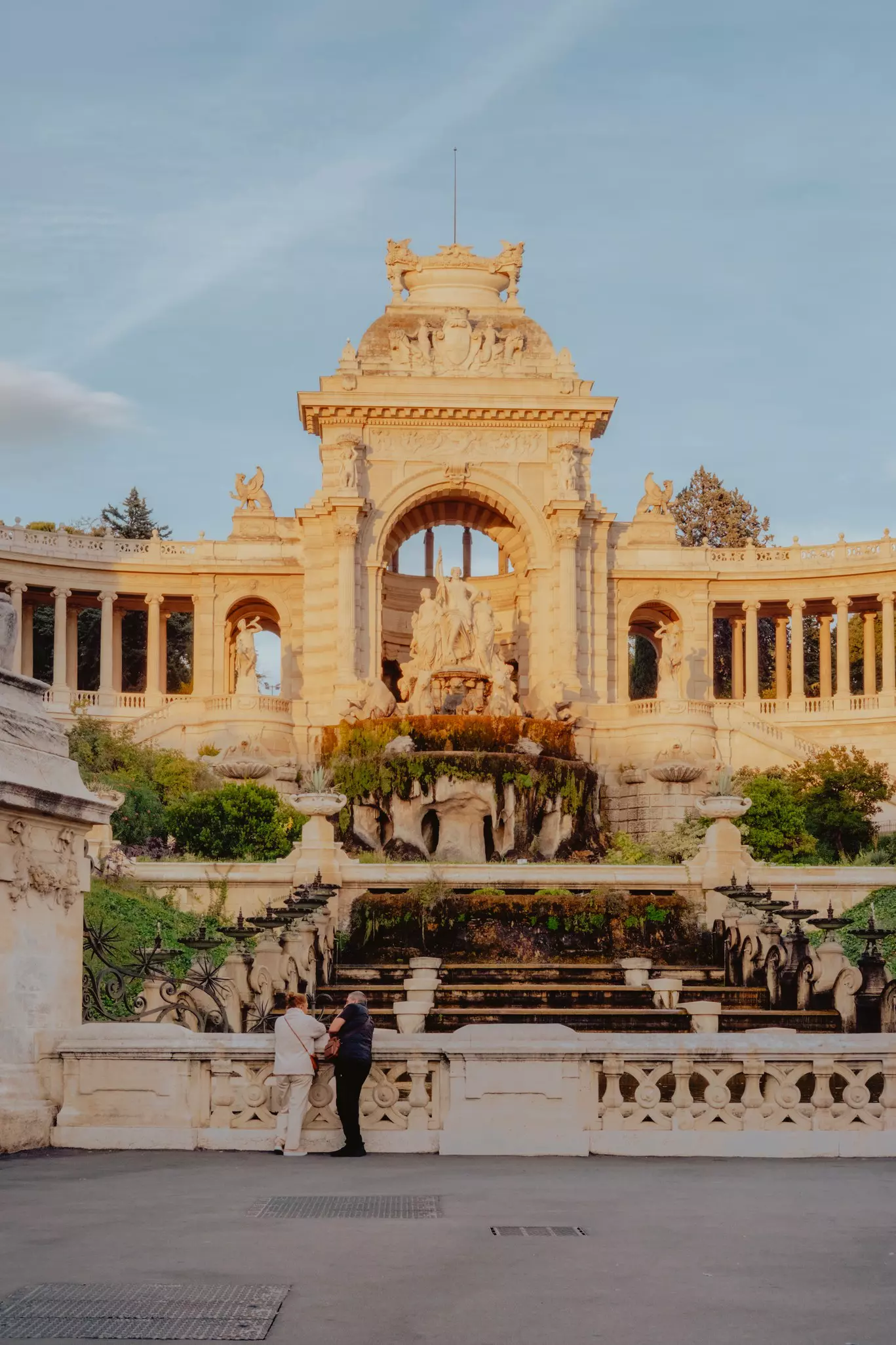 An ornate building with fountains and arches