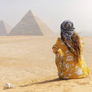 A female tourist sitting on a sand dune and looking at the Pyramids of Giza.
1135422752
Desert, Khafre, Copy Space, Egypt, Photography, Ancient History, Travel Destinations, Horizontal, Only Women, Human Back, Ancient, Pyramid, Young Adult, Archaeology, Pharaoh, Adults Only, Middle East, Tourism, Women, Architecture, Tourist, Giza Pyramids, Awe, History, Females, Capital Cities, One Woman Only, Kheops Pyramid, Adult, Looking At View, Antique, Cairo, Explorer, Old Ruin, Egyptian Culture, Cultures, Giza, Young Women, The Past, Caucasian Ethnicity, Africa, Pyramid of Mycerinus, Travel, Back, Ancient Egyptian Culture, Monument, UNESCO World Heritage Site, Temple - Building, Pyramid Shape, People, Rear View, Famous Place, International Landmark, Majestic, Pyramid of Chephren, Ancient Civilization, Vacations, One Person, One Young Woman Only, Journey