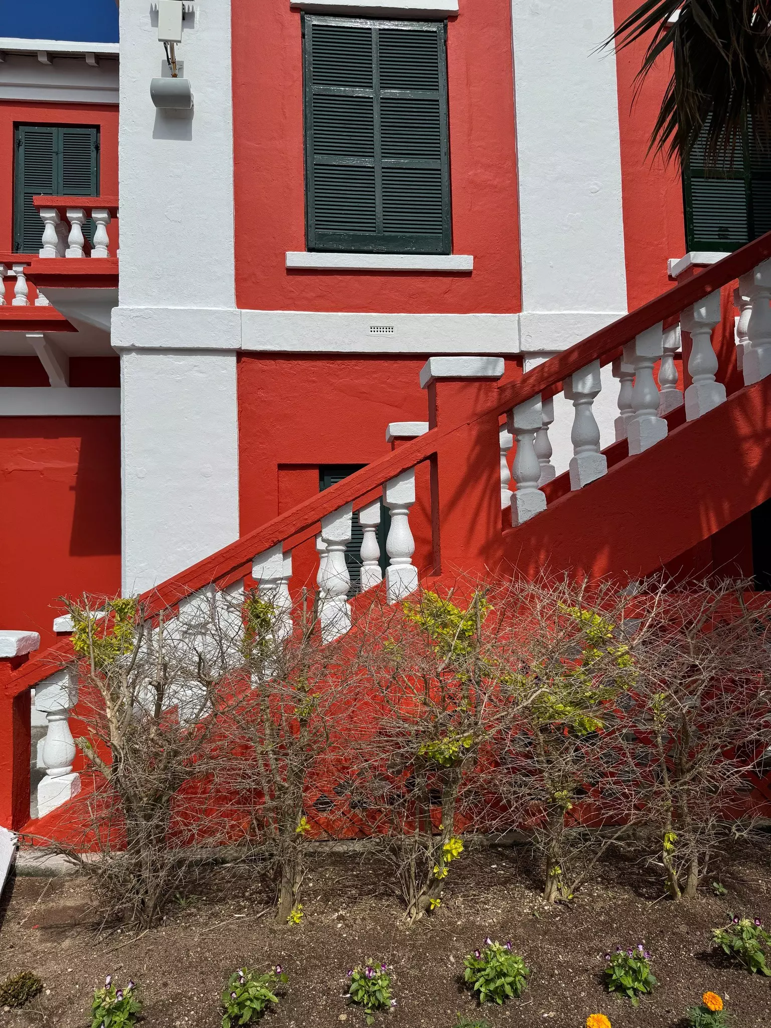 Details on a staircase at a red and white building.