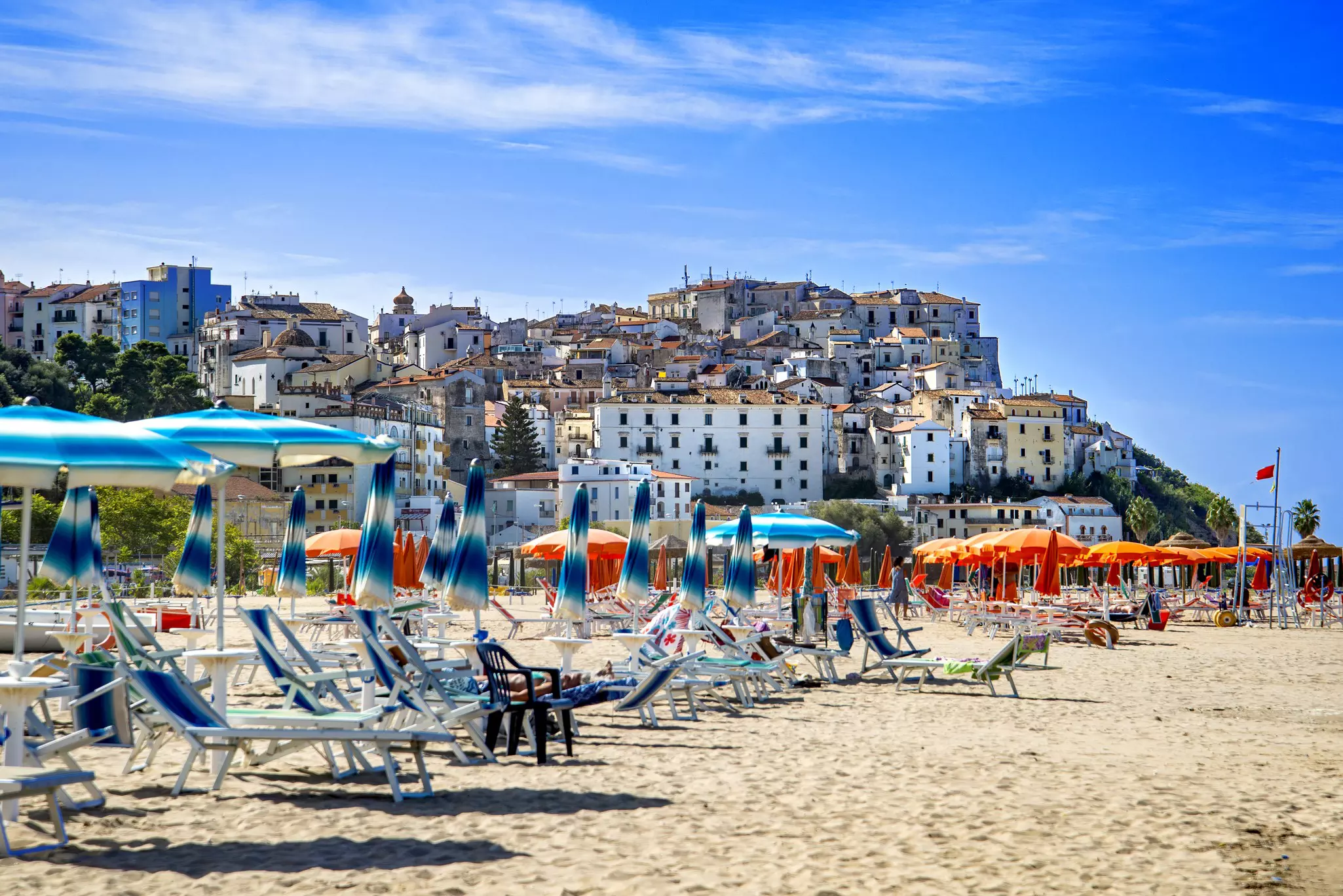 Umbrellas and lounge chairs on the beach of Rodi Garganico in Puglia, Italy.