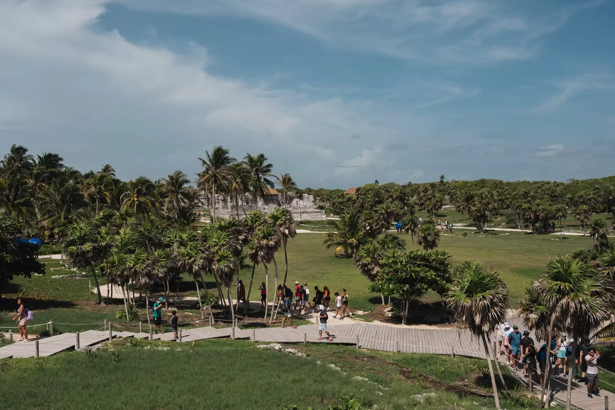 Aerial view of visitors walking towards the Tulum Ruins at the Parque del Jaguar in Mexico.