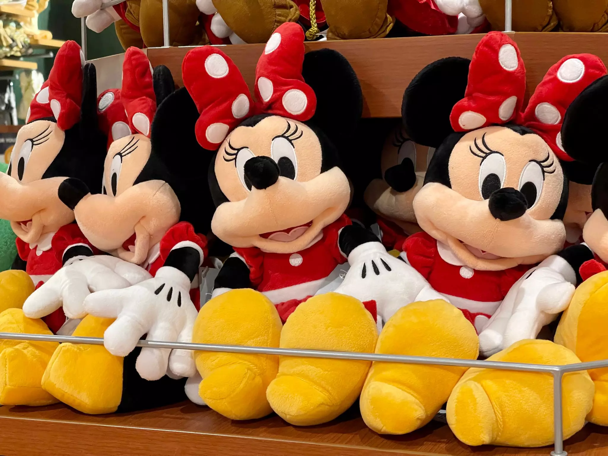 Minnie Mouse plush toys in a Disney souvenir store.